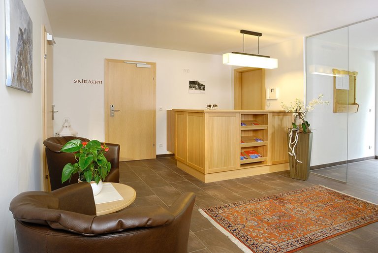 Eingangsbereich mit Rezeption und Sitzgelegenheit im Hotel Dorfblick
